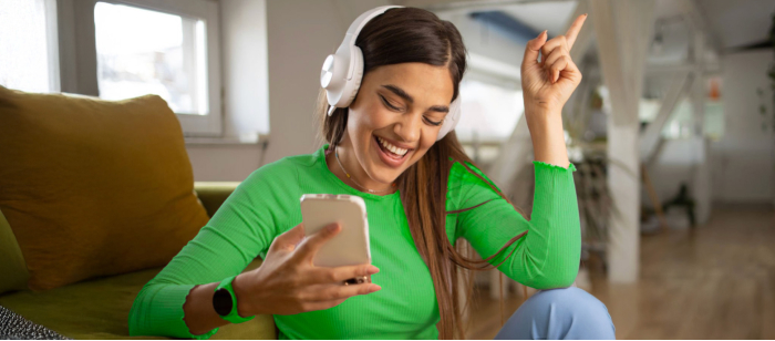 Woman with phone and headphones